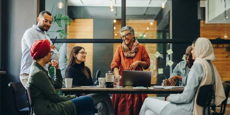 A group of employees collaborating around a table.