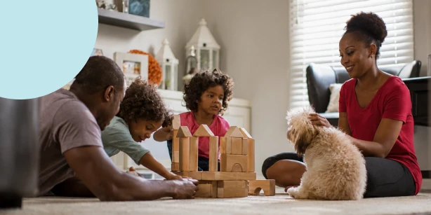 A family of four and their dog, happily spending quality time together, illustrating the peace of mind that a secure legacy brings through an estate plan.