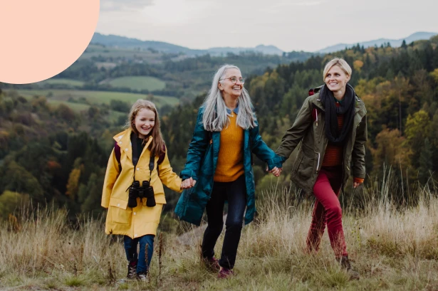 Three generations of women in a family walking in a scenic landscape, representing confidence that their futures are secure with legacy planning strategies that build generational wealth.