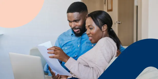 A couple looking at their financial statements as they prepare to start saving money.