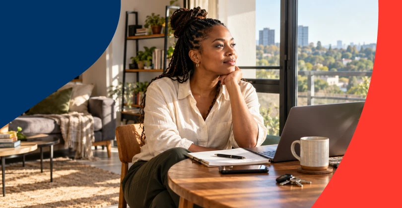 A young woman stares into the distance while imagining her future financial goals.