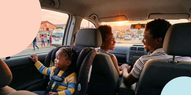 Image of a mother buckling up her toddler in a car seat.