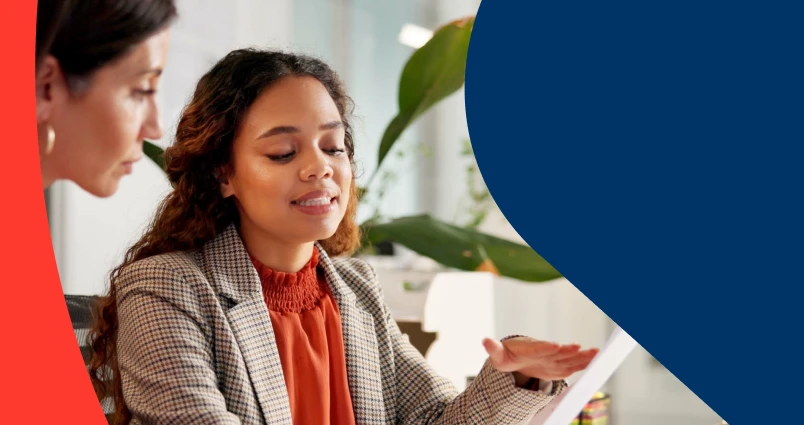 Professional speaking to her financial adviser and reviewing her financial statement during a face-to-face consultation. 