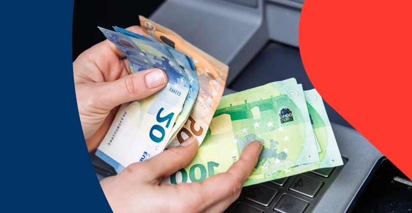 Close-up of cash being handled at an ATM with a blue and red overlay, representing the increase in early retirement savings withdrawals under the current two-pot retirement system regulations.