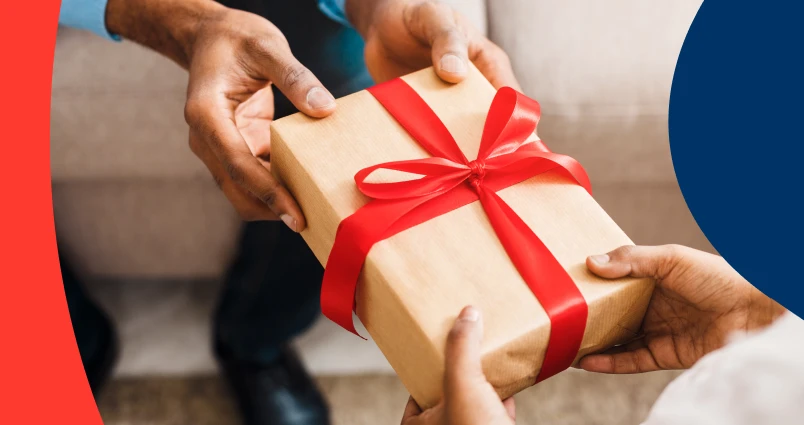 Two people sharing a gift, symbolising how practicing generosity can lead to a healthier and more balanced relationship with money.