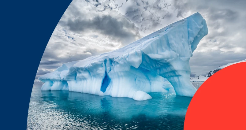 A massive blue-and-white iceberg floating in clear ocean water with cloudy skies in the background, metaphorically representing the biggest retirement costs people overlook.