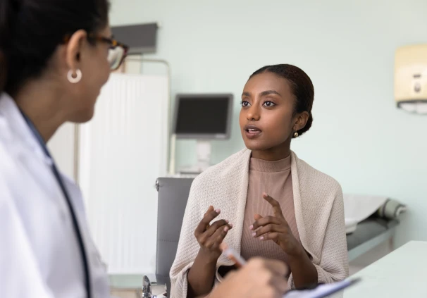 A young woman informing her doctor about a living Will she has in place in case something happens to her. 