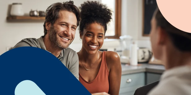 A happy couple seeking financial advice, consulting with an adviser.