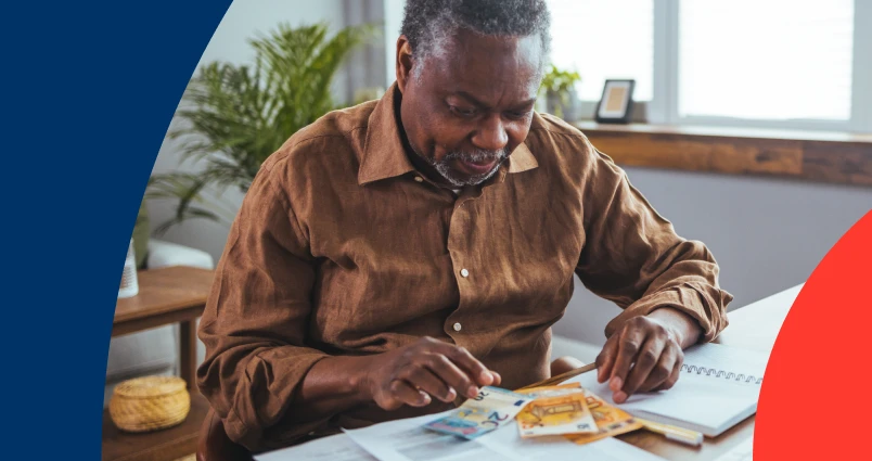 A middle-aged man counting money notes and probably thinking of where to get financial advice.
