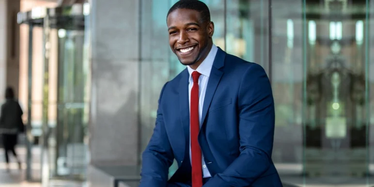 A successful male financial adviser in corporate business attire, illustrating an elevated financial planning practice.
