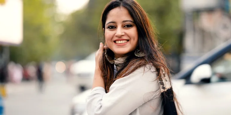 A smiling young woman outdoors, representing a new-to-industry graduate starting a financial adviser career with Momentum.