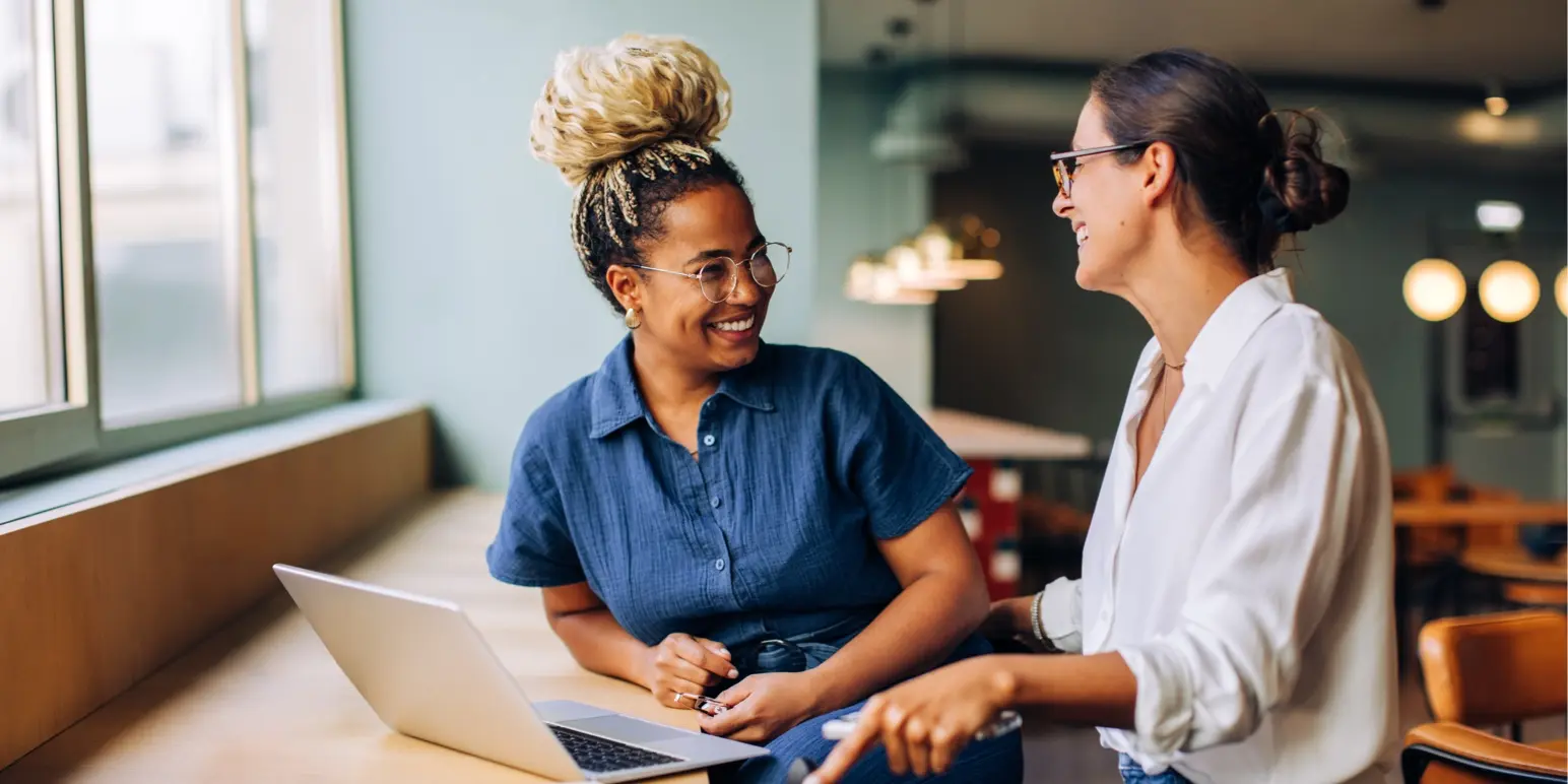Two female colleagues in a counseling or support meeting representing the Momentum Employee Assistance Programme.