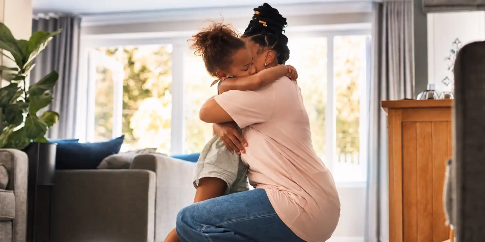 Mother hugging her child at home representing compassionate funeral assistance service support for FundsAtWork members.