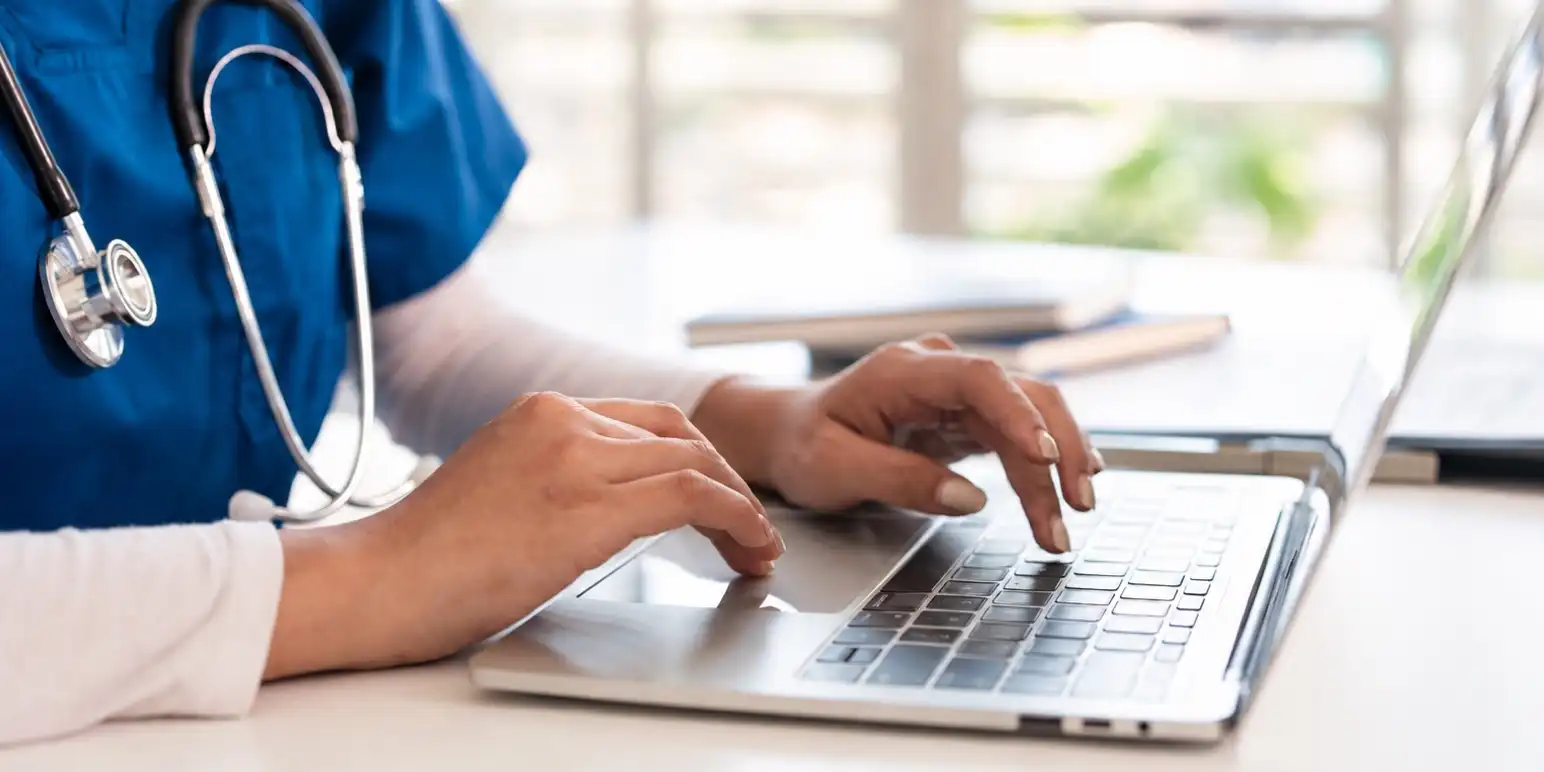 Medical practitioner using a laptop representing Hello Doctor telehealth access and virtual medical advice for members.