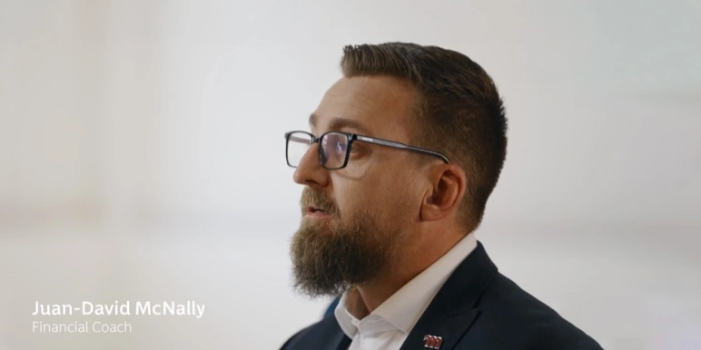 Close-up of Juan David McNally, a Financial Coach at Momentum Corporate, speaking about employee benefits beneficiaries.