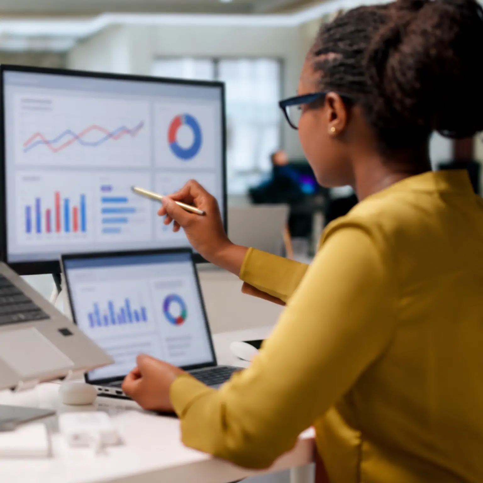 Financial administrator reviewing fund performance analytics on desktop monitors representing Momentum Retirement Administrators.