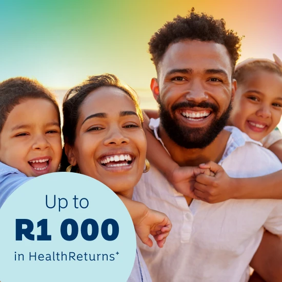 A smiling South African family of four enjoying time outdoors at sunset, promoting affordable and cheap medical aid in South Africa with up to R1 000 in HealthReturns rewards.