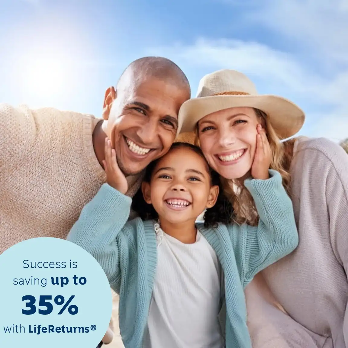 Parents enjoy a day outdoors with their young daughter. The daughter is standing in the middle of them with her hands on each parent's cheeks.
