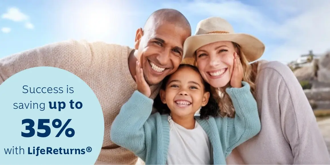 Parents enjoy a day outdoors with their young daughter. The daughter is standing in the middle of them with her hands on each parent's cheeks.