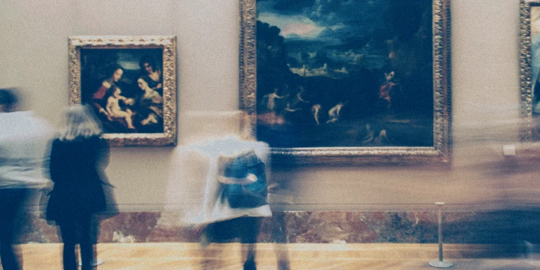 Blurred motion of visitors walking past large framed paintings in an art museum, creating a sense of movement against the still artwork.
