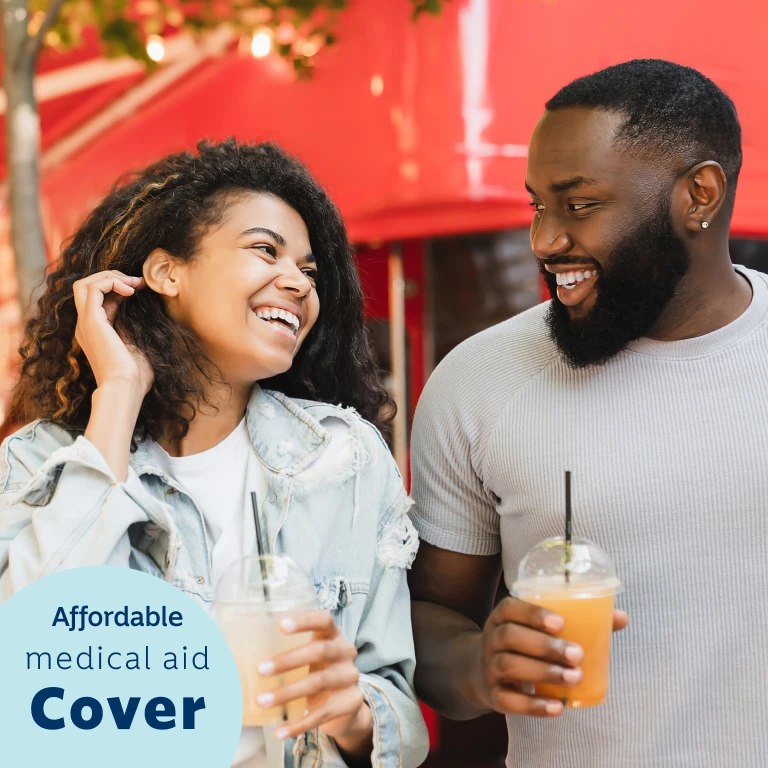 A young female and male holding smoothies chatting about the Ingwe Option from Momentum Medical Scheme that's suitable for first time earners and students.