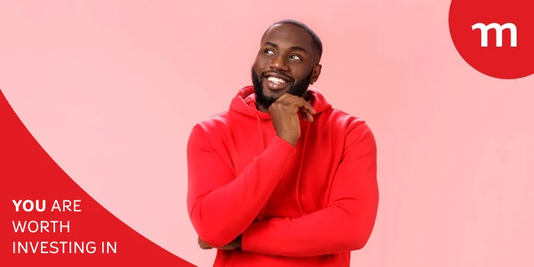 Young black man in a red sweater posing with his hand on his chin.