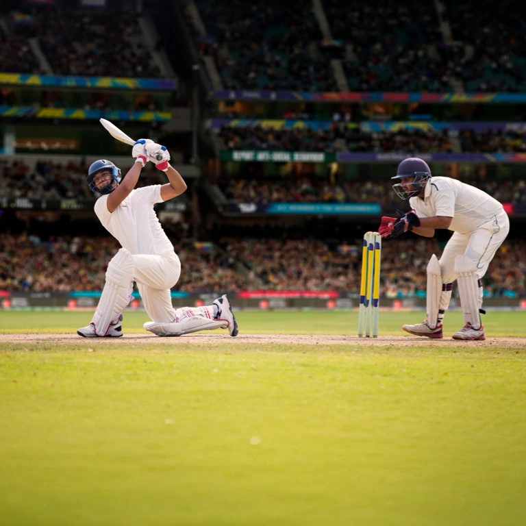 A cricket batter sends the ball soaring high over the boundary for a six, symbolising a powerful, game-changing move, like a single lump sum that significantly boosts retirement savings.