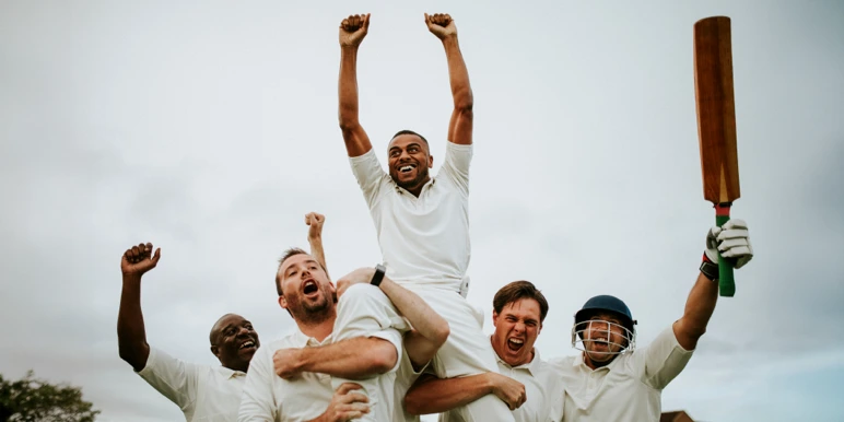 A winning cricket team gathered in celebration, representing how each lump-sum contribution multiplies over time through compound interest to deliver long-term savings growth.