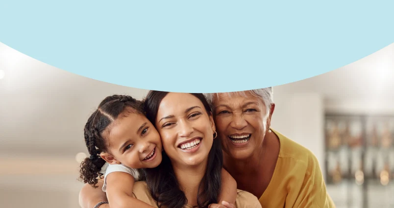 A mother, daughter and grandmother sharing a happy moment, enjoying the peace of mind that comes with financial security and knowing that investing for the long term can help build a secure future for generations to come.